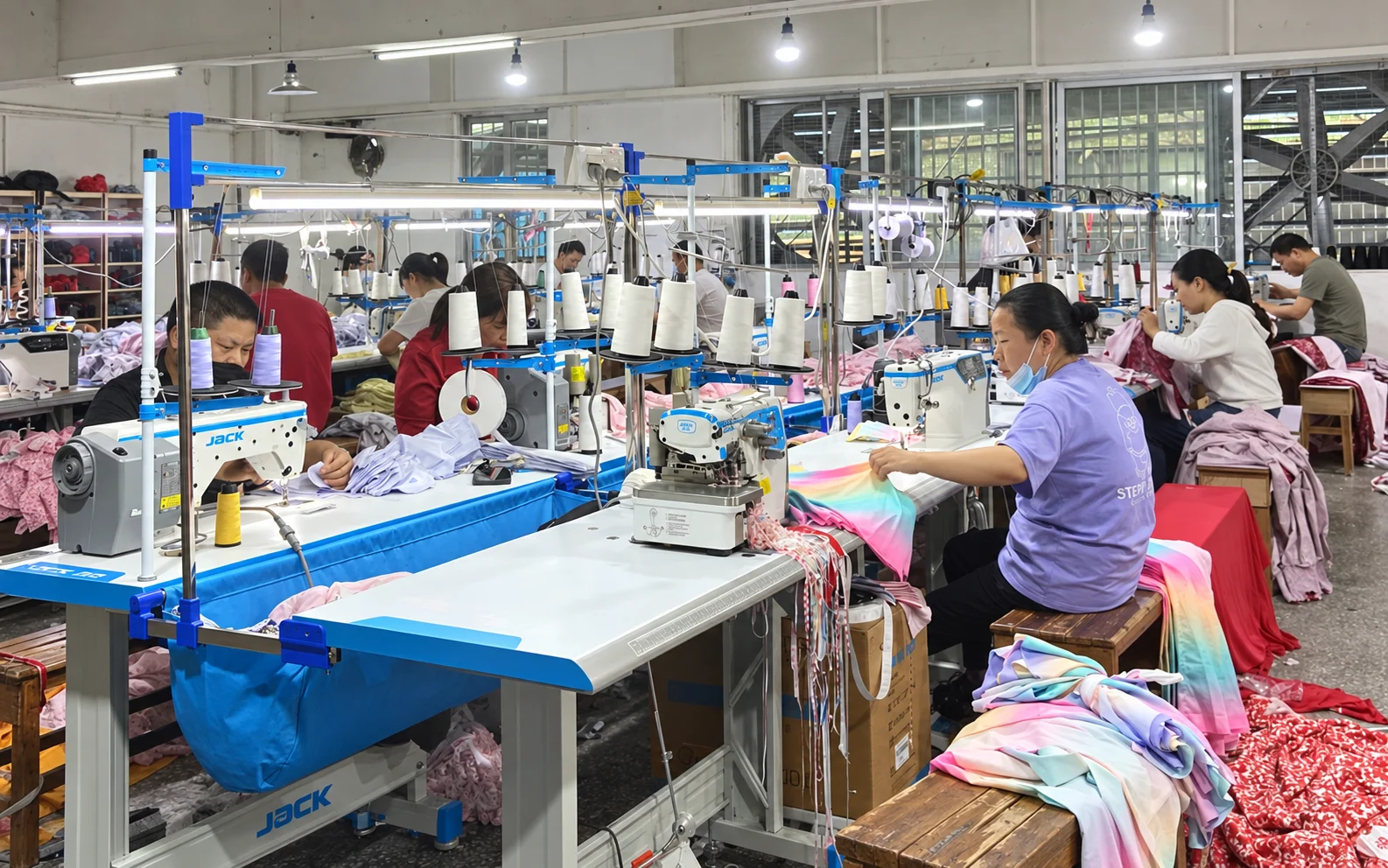 Workers sewing garments inside YX Custom Clothing production workshop