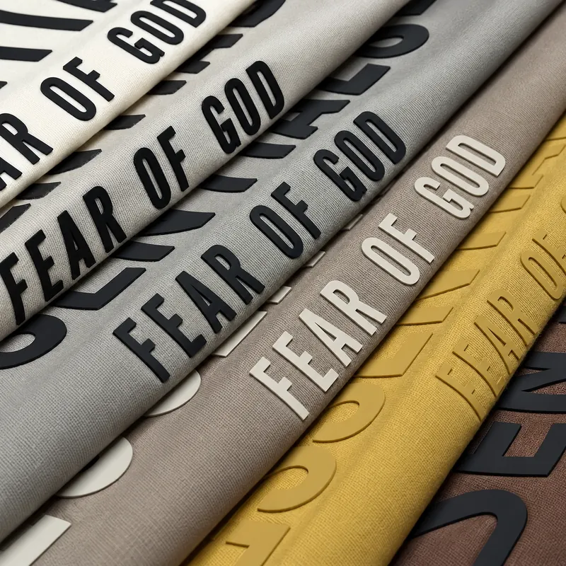 Raised silicone lettering on overlapping fabric samples